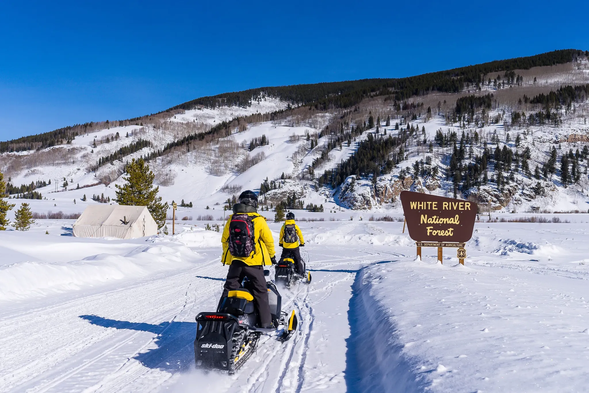Riders on a family-friendly Prospector guided snowmobile tour near Keystone, Colorado.